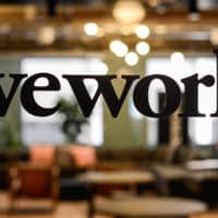 A WeWork logo is seen at a WeWork office in San Francisco in September. | REUTERS
