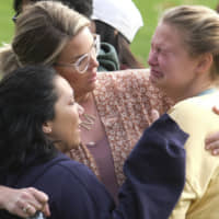 Students are comforted as they wait to be reunited with their parents following a shooting at Saugus High School that injured several people, Thursday in Santa Clarita, California. | AP
