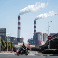 The Shanghai Waigaoqiao Power Generator Co.\'s coal-power plant emits smoke in Shanghai. | AFP-JIJI