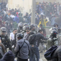 Police disperse anti-government protesters during a nationwide strike, at Bolivar square in downtown Bogota Thursday. Colombia\'s main union groups and student activists called for a strike to protest the economic policies of Colombian President Ivan Duque and a long list of grievances. | AP