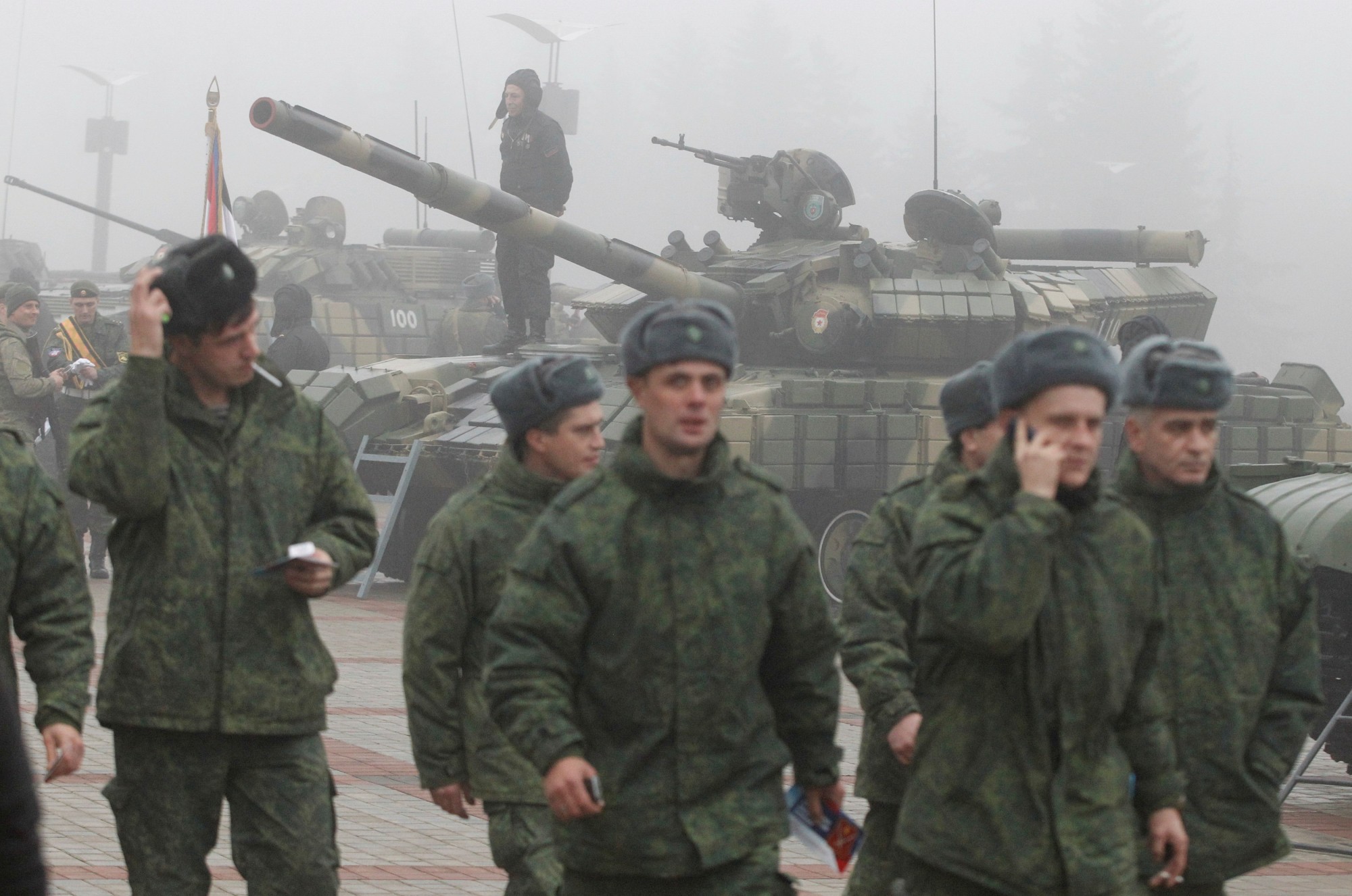Servicemen attend an army equipment and weaponry exhibition marking the fifth anniversary of the creation of the separatist Donetsk People's Republic's armed forces on a foggy autumn day in Donetsk, Ukraine, Tuesday. | REUTERS
