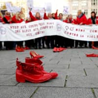 Red shoes are placed on the ground during a demonstration against all kinds of violence toward women, in central Brussels Sunday. | REUTERS