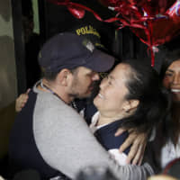 Keiko Fujimori is embraced by her husband, Mark Vito Villanela, after she was released from the Chorillos prison in Lima late Friday. | AP