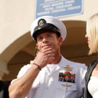 U.S. Navy SEAL Special Operations Chief Edward Gallagher prepares to answer a question from the media with his wife, Andrea Gallagher, after being acquitted on most of the serious charges against him during his court-martial trial at Naval Base San Diego on July 2. | REUTERS