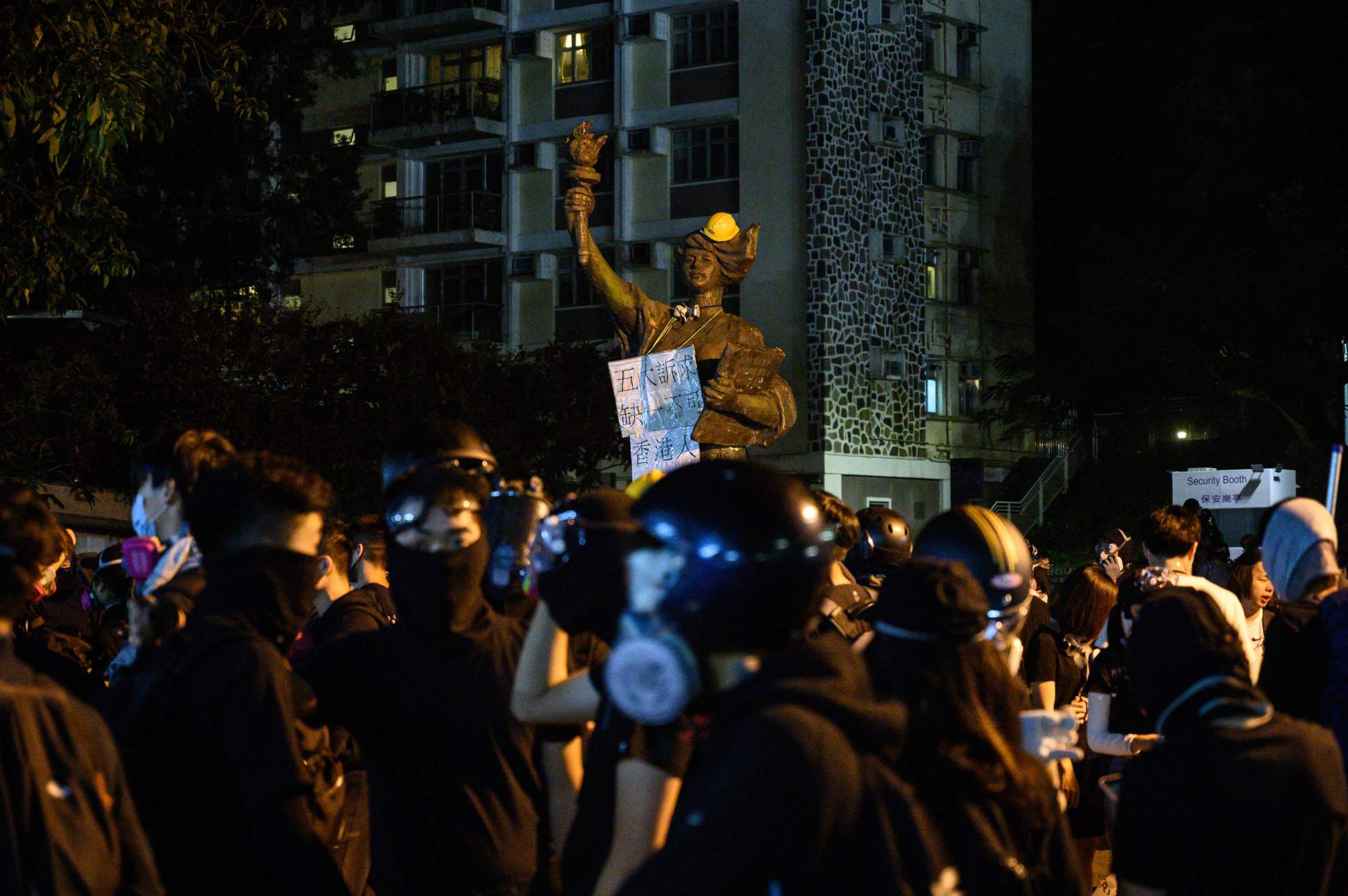 Protesters gather in front of the 'Goddess of Democracy' statue on campus after clashes with police at the Chinese University of Hong Kong (CUHK), in Hong Kong early Wednesday. Hong Kong pro-democracy protesters clashed with riot police in the city's upmarket business district and on university campuses Tuesday, extending one of the most violent stretches of unrest seen in more than five months of political chaos. | AFP-JIJI