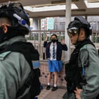 A student is questioned by police in the Sai Wan Ho district of Hong Kong on Monday following a day of pro-democracy protests. | AFP-JIJI