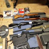 This handout picture made avalaible by Italian police press office Thursday shows automatic weapons, rifles, crossbows, swords, knives and Nazi books on dictator Benito Mussolini found during a search at the homes of 19 suspects throughout the country. Italian police cracked open an armed neo-Nazi group they said had been forging contacts with extremists elsewhere in Europe. | ITALIAN POLICE / VIA AFP-JIJI