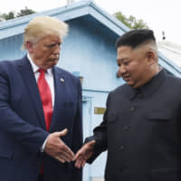North Korean leader Kim Jong Un and U.S. President Donald Trump shake hands at the South Korean border village of Panmunjom in the Demilitarized Zone on June 30. | AP