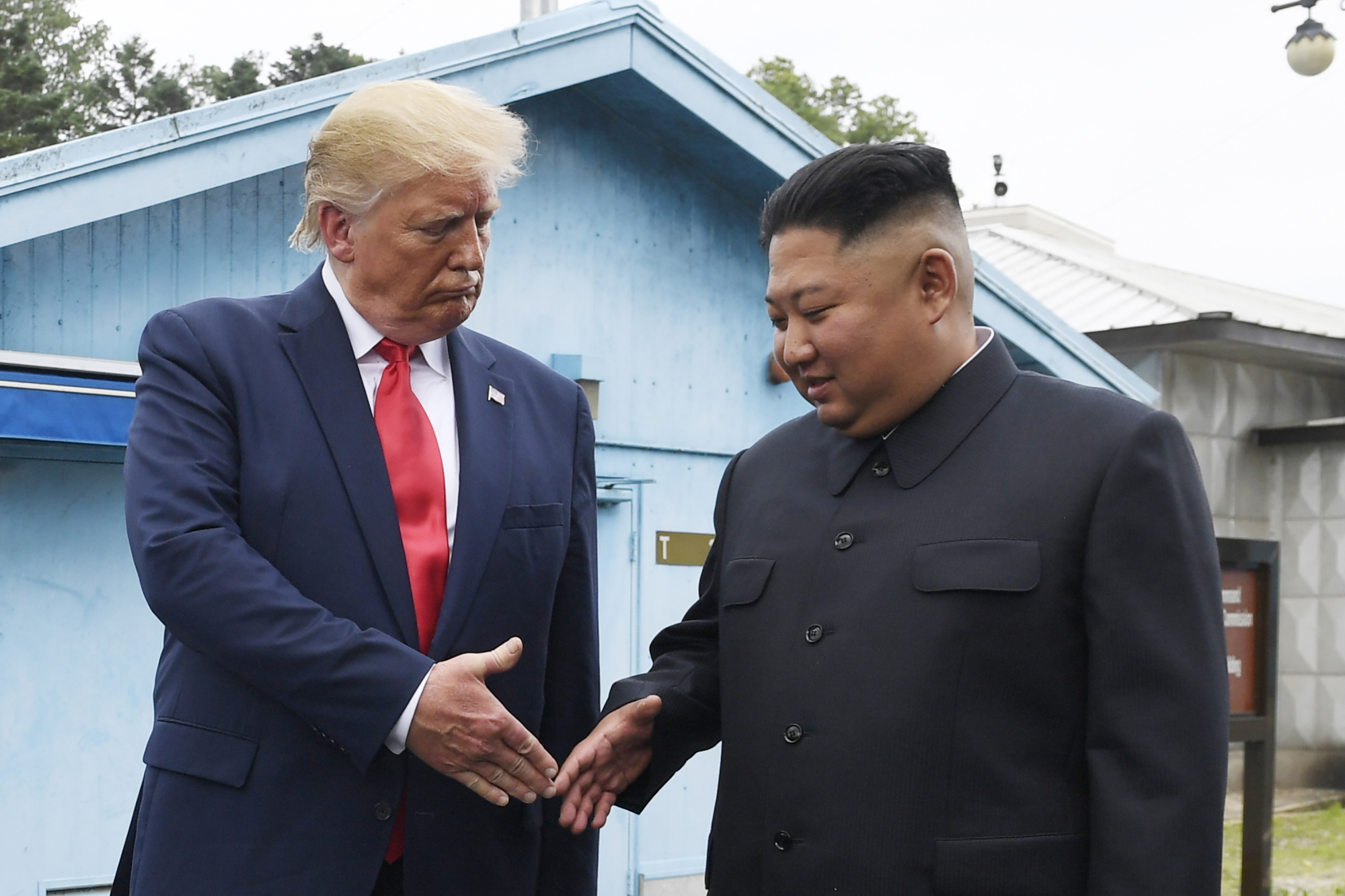 North Korean leader Kim Jong Un and U.S. President Donald Trump shake hands at the South Korean border village of Panmunjom in the Demilitarized Zone on June 30. | AP
