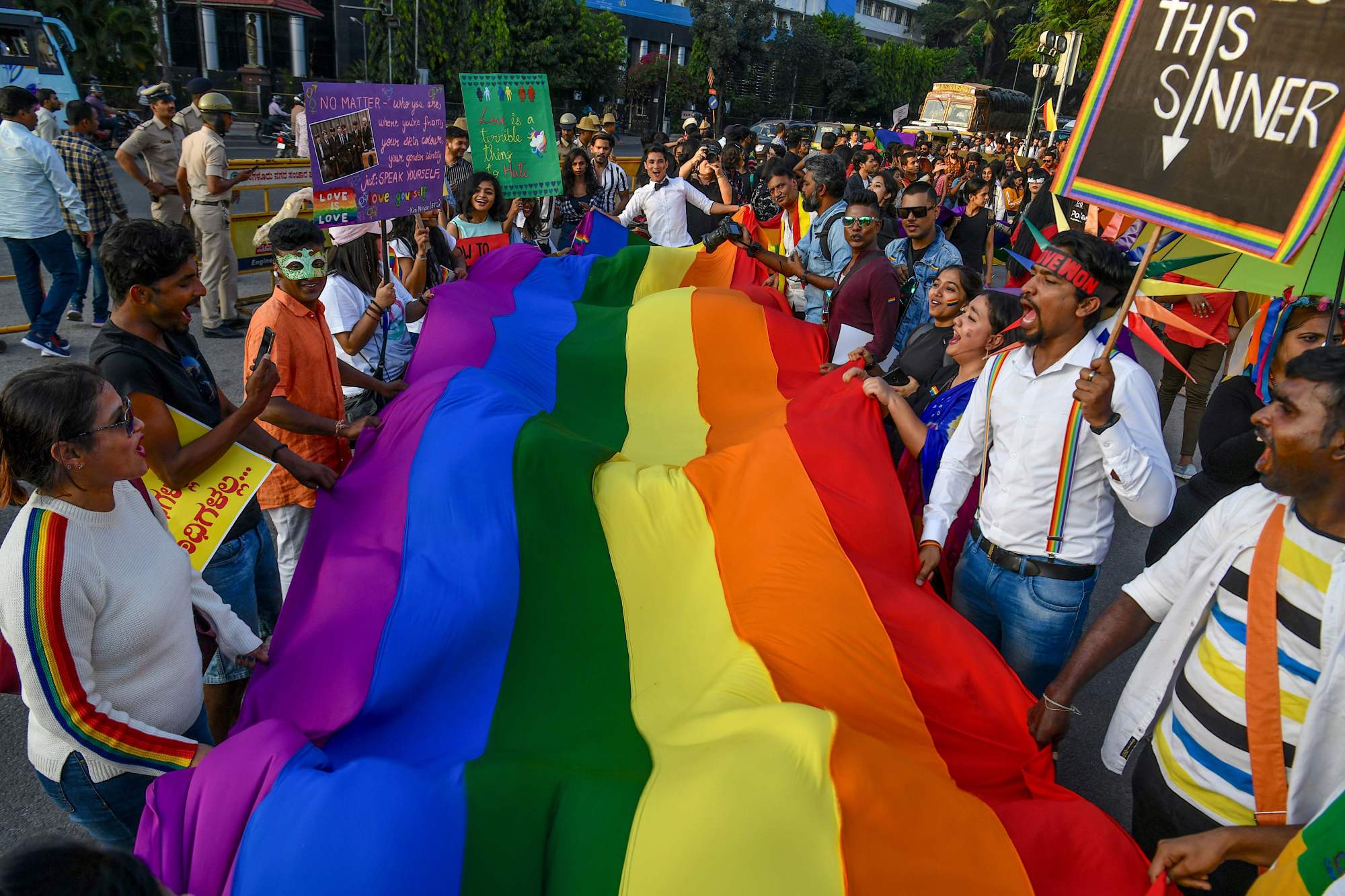 People hold a rainbow flag as they take part in an annual pride parade organized by the Coalition of Sex Workers', Sexual and Sexuality Minorities' Rights in Bangalore, India, on Sunday. | AFP-JIJI