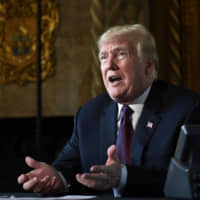U.S. President Donald Trump speaks to reporters following his teleconference with troops from his Mar-a-Lago estate in Palm Beach, Florida, on Nov. 22 last year. | AP