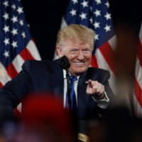 U.S. President Donald Trump gestures as he speaks at his Black Voices for Trump rally Friday in Atlanta. | AP