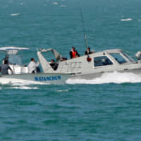 A Mexican patrol boat (right) checks the boat of a fisherman as they stand guard over California Gulf porpoises, also known as vaquitas, in San Felipe in Mexico\'s state of Baja California in 2008. The vaquita, a tiny stubby-nosed porpoise found only in Mexico\'s Sea of Cortez, is on the brink of extinction as more die each year in fishing nets than are being born, biologists say. | REUTERS