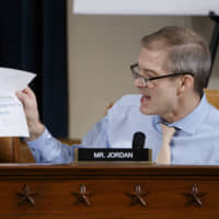Rep. Jim Jordan, a Republican from Ohio, holds a paper displaying a tweet from 2017 by Mark Zaid, one of the attorneys for the whistleblower whose complaint underpinned the start of the inquiry, during a House Intelligence Committee impeachment inquiry hearing in Washington on Tuesday. | SHAWN THEW / EPA / VIA BLOOMBERG