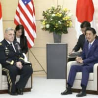 U.S. Chairman of the Joint Chiefs of Staff Gen. Mark Milley and Prime Minister Shinzo Abe hold talks in Tokyo on Tuesday. | KYODO