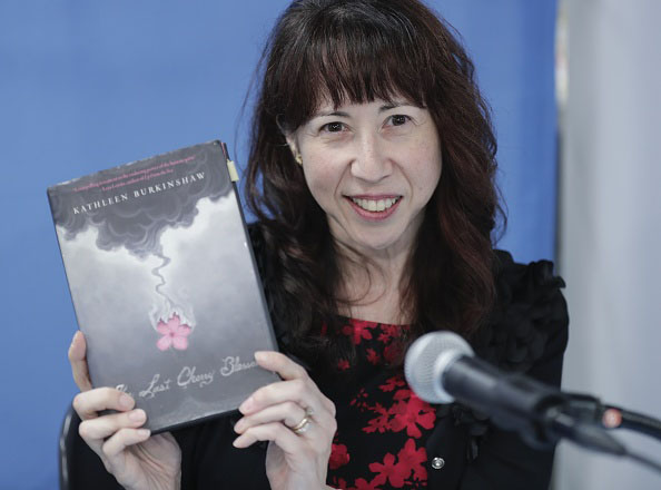 Kathleen Burkinshaw, author of 'The Last Cherry Blossom,' holds up a copy of her book at the U.N. on Nov. 5. | GETTY IMAGES