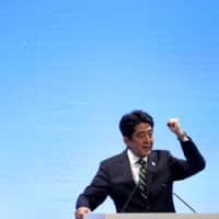 Prime Minister Shinzo Abe delivers a speech to the Liberal Democratic Party during the LDP\'s annual convention in Tokyo in March 2013. | AP