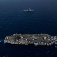 The forward-deployed aircraft carrier USS Ronald Reagan sails alongside the Maritime Self-Defense Force guided-missile destroyer Myoko in the Philippine Sea on Aug. 15. | U.S. NAVY