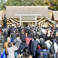 People visit the Daijokyu Halls at the Imperial Palace grounds in Tokyo on Thursday after they opened for a public viewing that will run daily through Dec. 8. Emperor Naruhito performed the Daijosai offering ceremony last week at the specially built halls. | KYODO