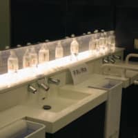 Water bottles are placed on washstands in a restroom at Haneda Airport on Wednesday morning after the water supply was cut off at its domestic terminals. | KYODO