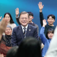 South Korean President Moon Jae-in appears on a TV program on Tuesday. | YONHAP / VIA KYODO