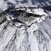 Mount Fuji\'s first snowcap of the season is seen on Oct. 23, a week before a 47-year-old man from Tokyo livestreamed his fatal fall from the summit. | KYODO