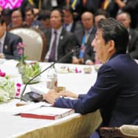 Prime Minister Shinzo Abe speaks at a meeting of the Association of Southeast Asian Nations leaders Monday on the outskirts of Bangkok. | POOL / VIA KYODO