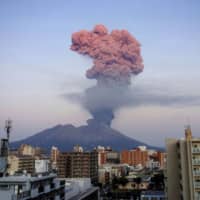 An ash plume from Mount Sakurajima towers over the clouds Friday in this photo by a weather observatory in Kyushu after the volcano had its biggest eruption in more than three years. | KYODO