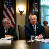 John Sullivan, U.S. deputy secretary of state (left) and Patrick Shanahan, then the U.S. deputy secretary of defense, listen as President Donald Trump speaks during a Cabinet meeting at the White House in May 2018. | GETTY IMAGES