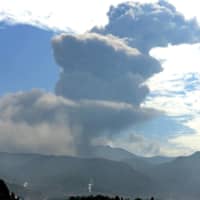 A plume of ash and smoke billows skyward from the crater of Mount Shinmoe, which straddles the Kagoshima-Miyazaki prefectural border, during an eruption in June last year. | KYODO