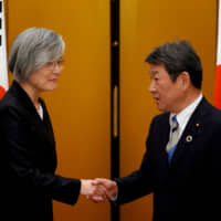 Foreign Minister Toshimitsu Motegi greets his South Korean counterpart, Kang Kyung-wha, after a G20 foreign ministers\' meeting in Nagoya on Saturday. | REUTERS