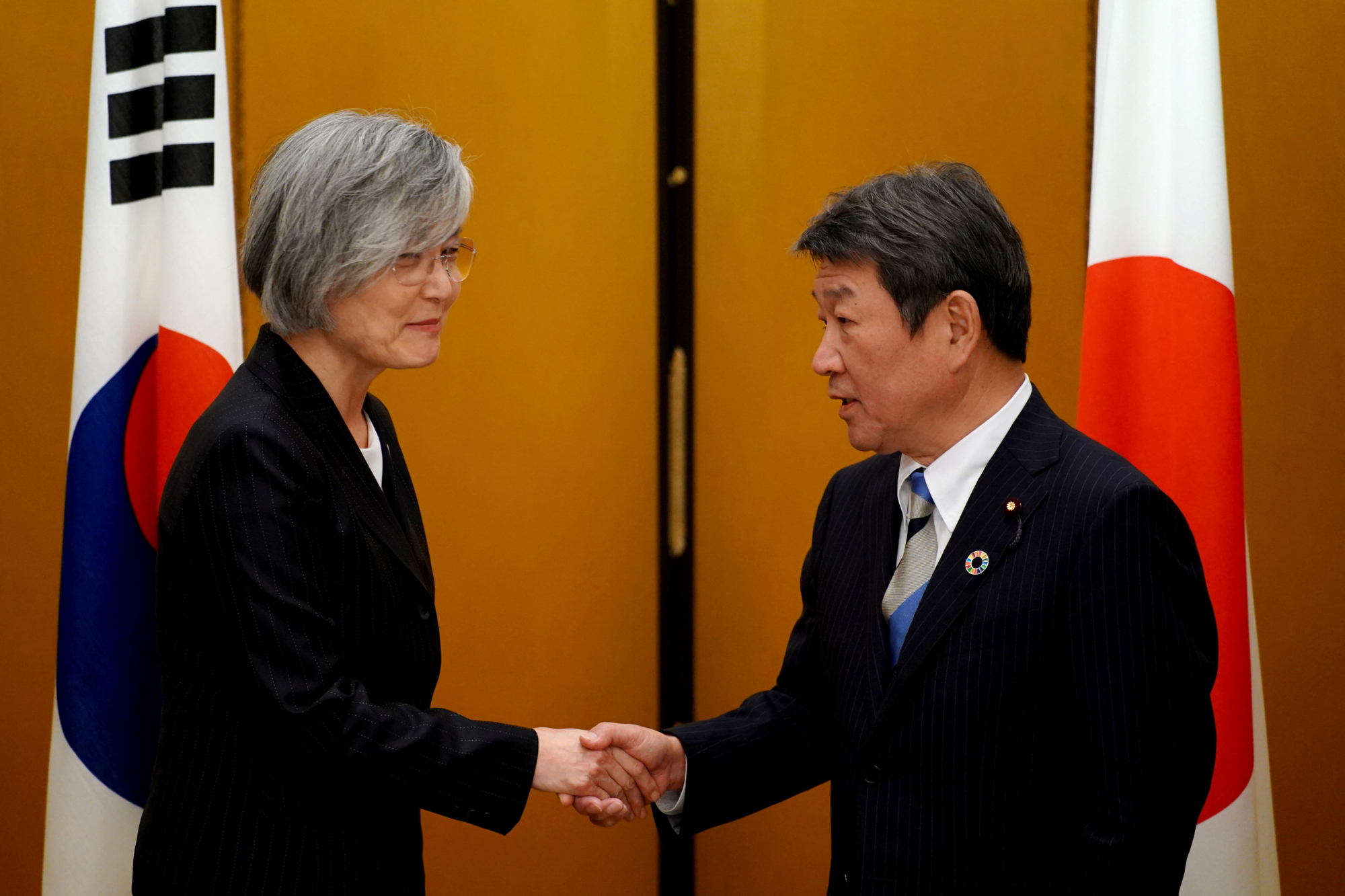Foreign Minister Toshimitsu Motegi greets his South Korean counterpart, Kang Kyung-wha, after a G20 foreign ministers' meeting in Nagoya on Saturday. | REUTERS