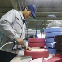 Getting the job done: A Vietnamese trainee works at a factory in Okazaki, Aichi Prefecture. | ?¯