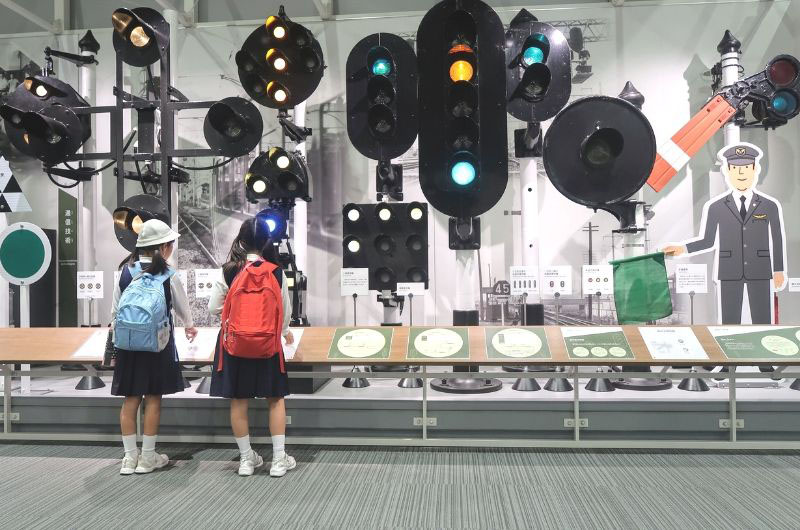 Children learn about train signals train signals at a display in the Kyoto Railway Museum. | JASON JENKINS