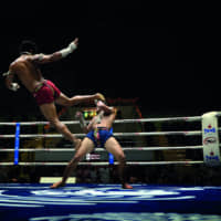 High-flying action: A muay thai fight at Lumpinee Stadium, which holds televised fights most evenings of the week. | PEERAPONG PRASUTR VIA WIKIMEDIA COMMONS / CC BY-SA 4.0