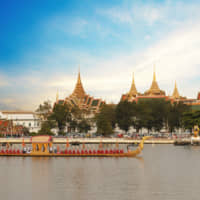 What fun: A barge passes in front of Wat Pho, which sits on the banks of Bangkok\'s Chao Phraya River. | GETTY IMAGES