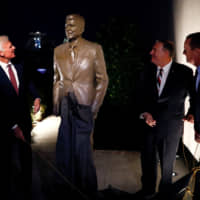 U.S. Secretary of State Mike Pompeo (second from right) attends the unveiling of a statue of U.S. President Ronald Reagan at the U.S. Embassy in Berlin on Nov. 9. Americans tend to credit Reagan\'s hard-line policies for ending the Cold War, but many Europeans emphasize the role played by constructive diplomacy. | REUTERS