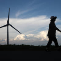 A wind turbine stands in Koriyama, Fukushima Prefecture. Last year, renewable energy sources excluding large-scale hydroelectric plants accounted for a mere 8 percent of Japan\'s total power supply | BLOOMBERG
