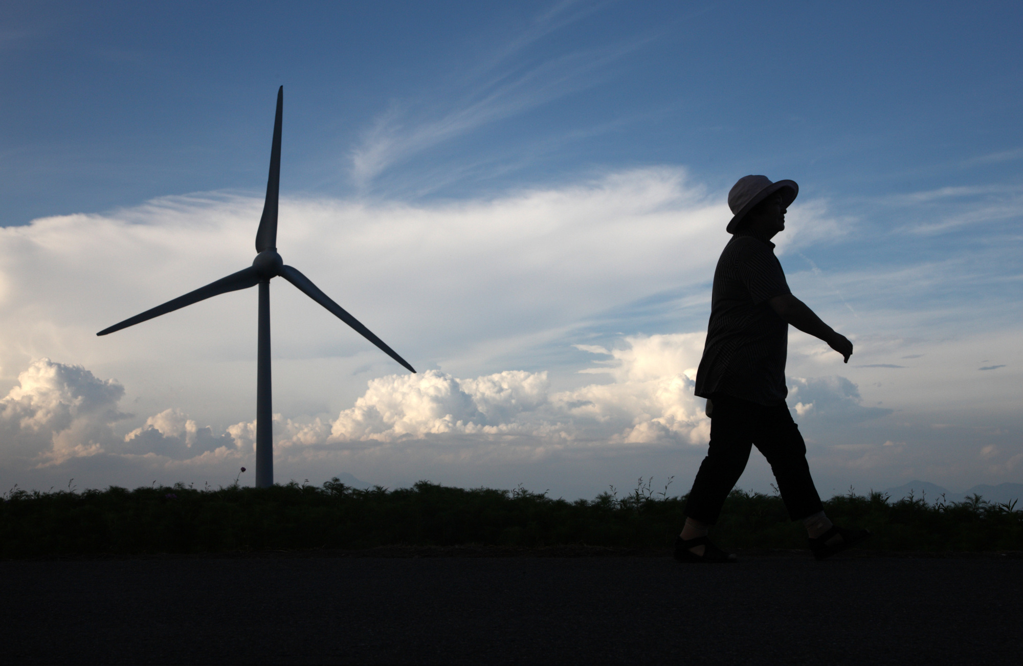A wind turbine stands in Koriyama, Fukushima Prefecture. Last year, renewable energy sources excluding large-scale hydroelectric plants accounted for a mere 8 percent of Japan's total power supply | BLOOMBERG