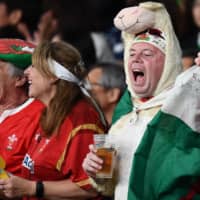 Wales supporters cheer during the bronze-medal match against New Zealand at Tokyo Stadium on Friday night. | AFP-JIJI
