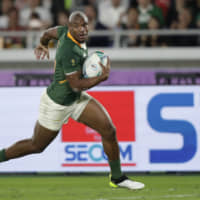 South Africa\'s Makazole Mapimpi scores a try in the second half against England in the Rugby World Cup final on Saturday night at International Stadium Yokohama. | AP
