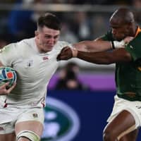 South Africa\'s Makazole Mapimpi (right) tackles England\'s Tom Curry in the Rugby World Cup final on Saturday at International Stadium Yokohama. | AFP-JIJI