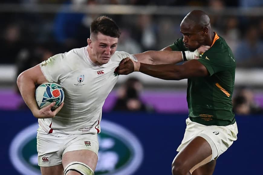 South Africa's Makazole Mapimpi (right) tackles England's Tom Curry in the Rugby World Cup final on Saturday at International Stadium Yokohama. | AFP-JIJI