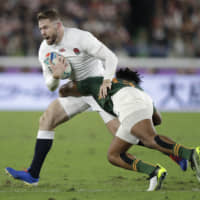 England\'s Elliot Daly is tackled by a South Africa player in the first half. | AP