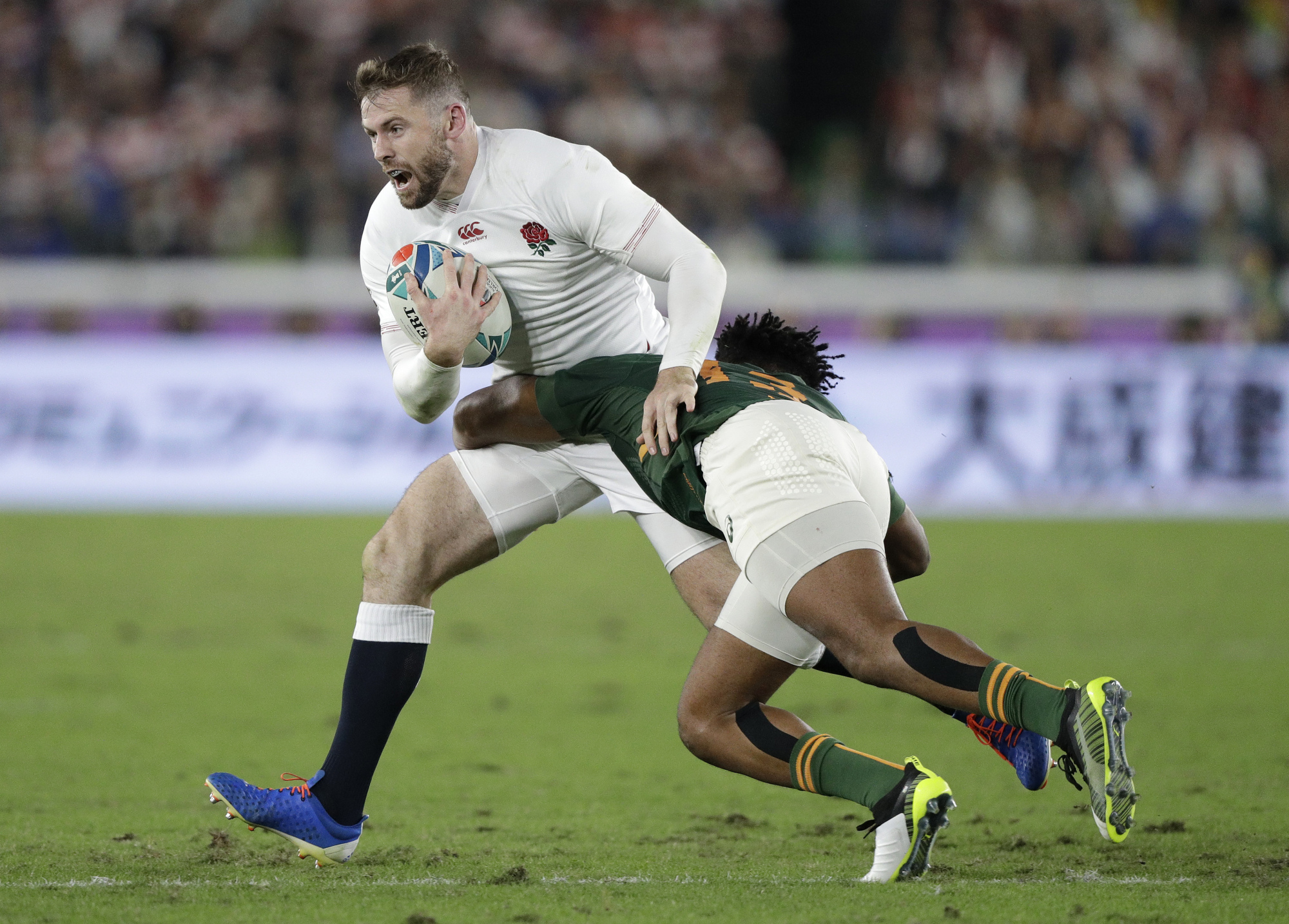 England's Elliot Daly is tackled by a South Africa player in the first half. | AP
