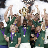 South Africa captain Siya Kolisi lifts the Webb Ellis Cup and celebrates with teammates after winning the Rugby World Cup final against England on Saturday at International Stadium Yokohama. | REUTERS