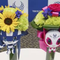 The final designs for bouquets to be presented to medalists at the Tokyo 2020 Olympic and Paralympic Games are displayed at a Tokyo news conference on Tuesday. | KYODO