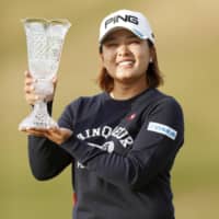 Ai Suzuki holds the trophy after winning the Toto Japan Classic on Sunday. | KYODO