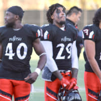 Fujitsu Frontiers running back Samajie Grant (center) reacts after the team\'s 31-13 win over the Elecom Kobe Finies on Saturday. | KAZ NAGATSUKA