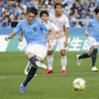 Yokohama FC\'s Yusuke Minagawa scores on a 32nd-minute penalty kick against Ehime FC on Sunday in Yokohama. | KYODO